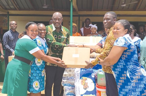 Nana Osei-Adjei (3rd from left), Member of Parliament for New Juaben North, presenting the medical equipment to the management of the Akwadum Health Centre