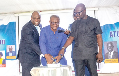 Prof. Amevi Acakpovi (left), VC, ATU, with Dr Emmanuel  Newman (middle), Director for Tertiary, at the Ministry of Education, and Prof. Ernest Abotsi, Chairman of ATU Governing Council, cutting a ribbon to launch the event