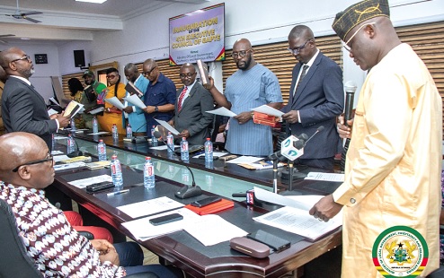 Ahmed Ibrahim (right), Minister of Local Government, Chieftaincy and Religious Affairs, swearing in the GAPTE Council members