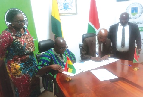 Samuel Kwaku Bonsu (2nd from left), Rector of GIMPA, and Prof. Jean de Dieu Ndikumana, Director-General of Ecole Nationale d'Administration, signing the MoU at the ceremony