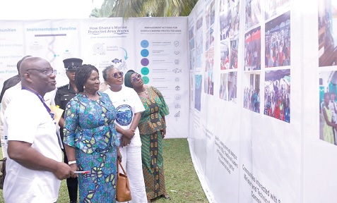 Prof. Naana Jane Opoku-Ageymang (2nd from left), Vice-President, and Emelia Arthur (2nd from right),  Minister of Fisheries and Aquaculture, and other dignitaries inspecting an exhibition of the activities and processes leading to the establishment of the MPA