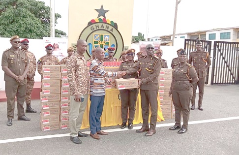 Dr Christopher Mensah (2nd from left), Managing Director of Tobinco Pharmaceuticals, presenting the items to Dr Francis Omane-Addo (2nd from right), Deputy Director-General, Operations. Looking on are Dr Augustina Ama Boadu (3rd from right), Assistant Director of Prisons, and other officers