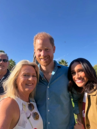 Narelle Zagami, a local resident, smiling with Harry and Meghan during the Scar Tree Walk in Melbourne.