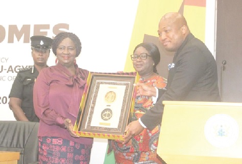 Prof. Naana Jane Opoku-Agyemang (left), Vice-President, receiving a symbolic gift from Samuel Okudzeto Ablakwa (right) and Ambassador Kadidja Iddrisu (middle), Chief Director, Ministry of Foreign Affairs