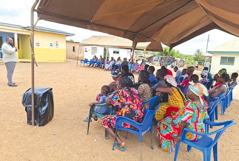 An official of the PURC educating some community members