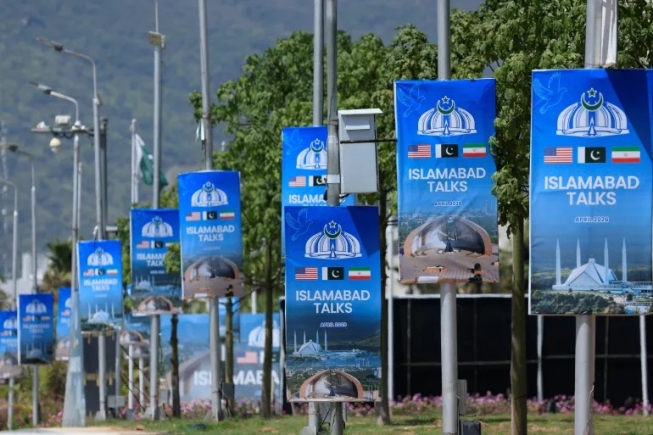 Hoardings are mounted on lamp posts, as Pakistan prepares to host the United States and Iran for a possible second phase of peace talks in Islamabad