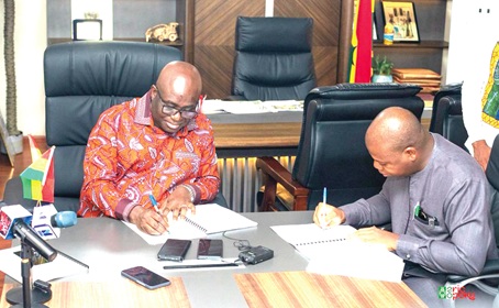 Eric Opoku (left), Minister of Food and Agriculture, signing the memorandum of understanding with Sena Amevor (right), Founder and CEO of FarmMate LTD