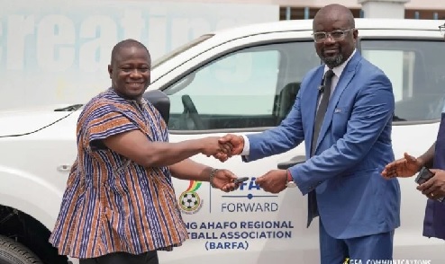Brong Ahafo Regional Football Association chairman Dr Charles Osei Antoh receiving the keys to his vehicle from Mr Okraku Brong Ahafo Regional Football Association chairman Dr Charles Osei Antoh receiving the keys to his vehicle from Mr Okraku