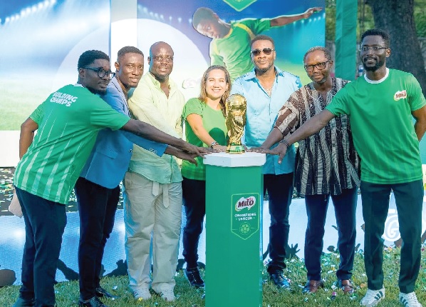 Salome Azevedo (middle), MD of Nestle Ghana Ltd, Stephen Appiah (3rd from left), Asamoah Gyan (3rd from right), both ambassadors, and other dignitaries holding the trophy at stake
