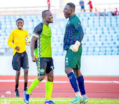 John Antwi  (left), Dreams FC Captain, and goalkeeper Gidios Aseako celebrating their victory over Medeama SC last Saturday