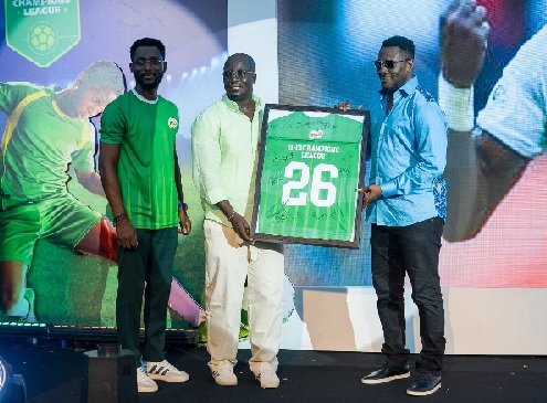 Asamoah Gyan (right) presenting the customised jersey to colleague Ambassador Stephen Appiah while Myron Otoo, Nestlé Ghana’s Category Manager for Beverages and Dairy looks on