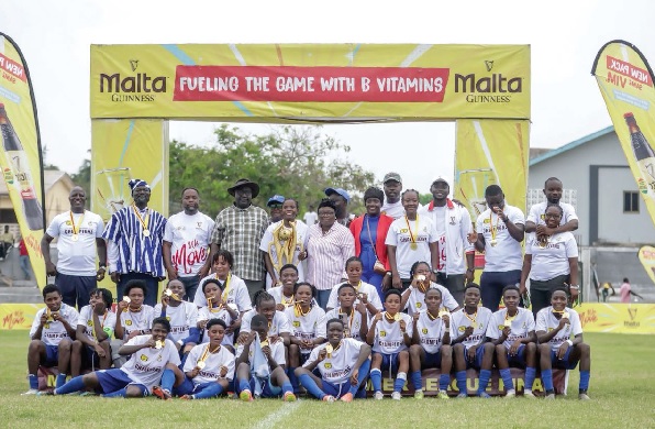 Players and officials of Ampem Darkoa Ladies celebrating with the league trophy and winners’ medals