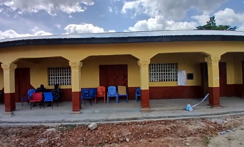 Looking on are the officials of ACA and the community