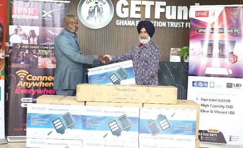 Amar Singh Hari (left), Executive Chairman, IPMC, presenting the items  to Paul Adjei (right), Administrator, Ghana Education Trust Fund.  Picture: BENEDICT OBUOBI