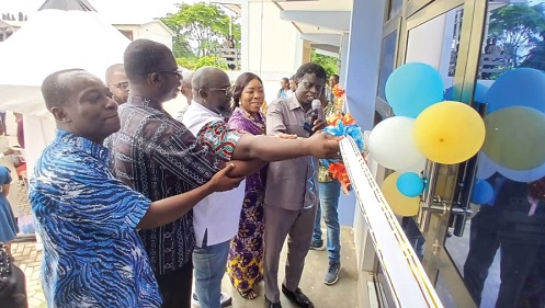 Prof. John Owusu (middle), being assisted by other partners to officially open the KTU incubation hub