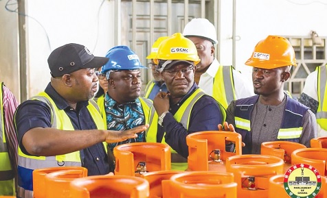 Abdul-Rahman Mankir (left), MD of the Ghana Cylinder Manufacturing Company, explaining the process involved in the refurbishment of cylinders at the company's factory
