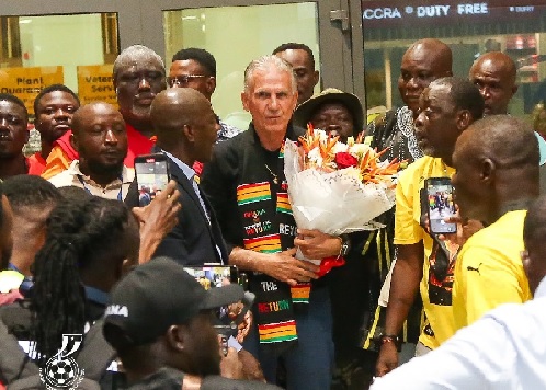 Hundreds of football-loving fans lined up at the airport to welcome Carlos Queiros amid drumming and dancing.