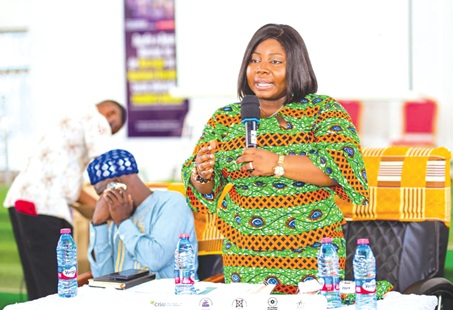 Patricia Pearl Ankrah, DCE for Afigya Kwabre South, addressing the gathering at a Town Hall meeting