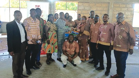 Richard Asumah, Headmaster of the school, receiving the items from Sylvia Amoro, President of the Kascity District Society of the Institute of Chartered Accountants, Ghana. With them are other members of the society