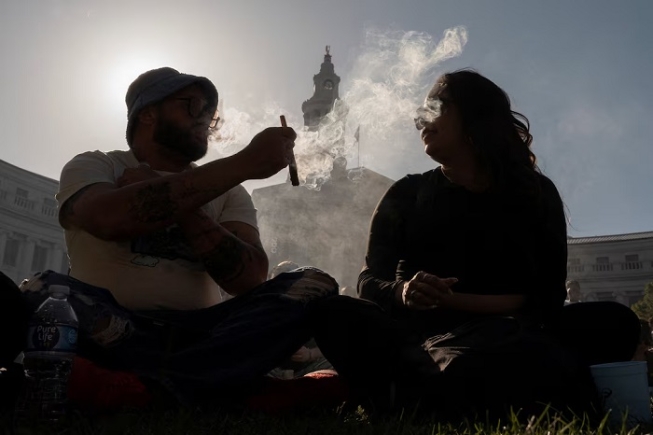 Revellers smoke cannabis at the Mile High 420 Festival in Denver, Colorado, U.S., April 20, 2026. REUTERS/Cheney Orr