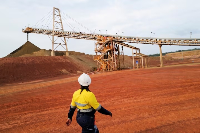 A mine worker walks near a conveyor belt as commercial gold production begins at the Newmont Ghana Gold Limited, Ahafo North Mine, in Afrisipakrom community in the Ahafo Region, Ghana. October 29, 2025. REUTERS/Francis Kokoroko/File Photo