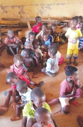 Some of the pupils on the bare floor for lessons