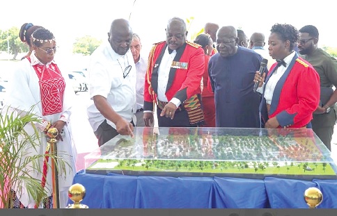 Lieutenant General William Agyepong (middle), the Chief of Defence Staff, showing Ibrahim Mahama (2nd from left), CEO of Engineers and Planners Limited, and Sam Jonah (2nd from right), Chancellor of the University of Cape Coast, the miniature version of the project
