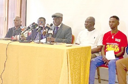 Martin Kpebu (middle) addressing the media