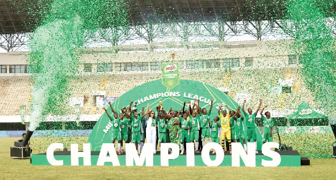 Players of Nkawkaw Salvation Army celebrating with the MILO U-13 Champions League trophy