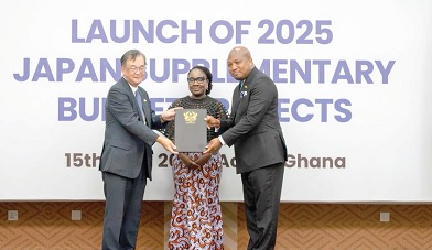 Samuel Okudzeto Ablakwa (right),  Minister of Foreign Affairs, and Hiroshi Yoshimoto (left), Japanese Ambassador to Ghana, displaying the supplementary fund document. With them is Dr Belinda Afriyie Nimako, a Public Health Physician