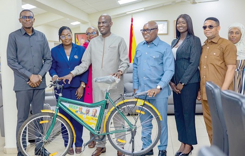 Haruna Iddrisu (5th from right), Education Minister, and leadership of the CTVET with the bicycle during the courtesy call