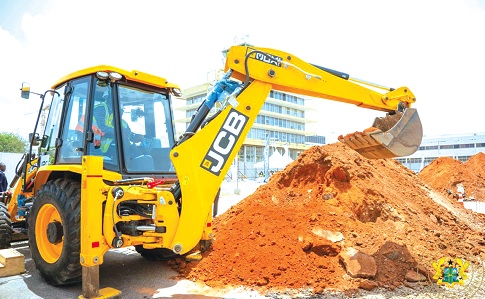 President John Dramani Mahama operating an excavator to break grounds for the construction of an interconnecting concourse to link Terminals Two and Three of the Accra International Airport