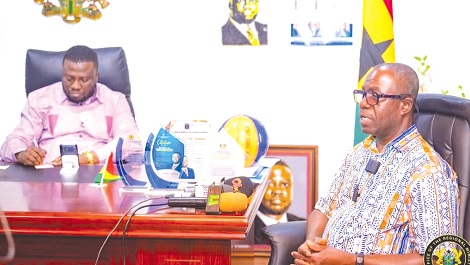 Julius Kwame Kpekpena (right), acting Managing Director, ECG, making a submission while Dr Frank Amoakohene, Ashanti Regional Minister, takes notes