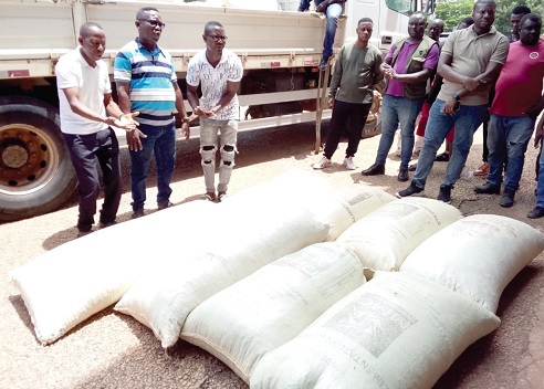 Three of the suspects (left) with some of the smuggled cocoa bags