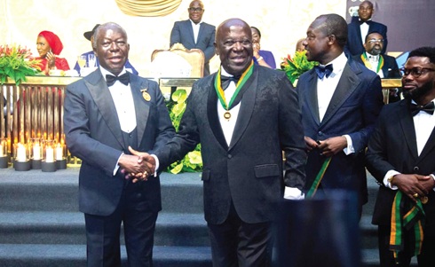 Otumfuo (left) congratulates Sir Sam Jonah