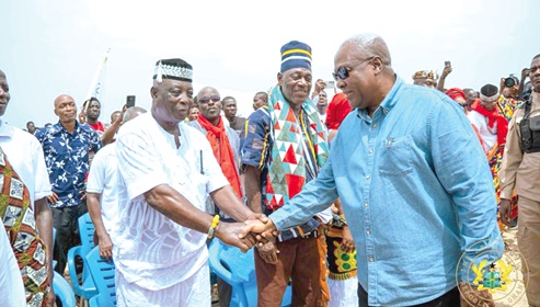 President Mahama (right) exchanging pleasantries with some community members at Fuveme 