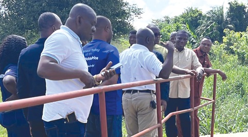 Members of the committee viewing the state of the Bonsa river