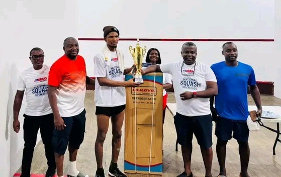 Nigerian 24-year Tosi Bejide (L) receiving trophy, others from GLICO General Tema Branch Manager, Felix Gbogbo (R), at the end of the GLICO General National Squash Open Championship 2026