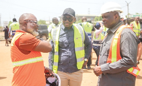 Wisdom Adonu (left), CEO of Mowlem International Limited, briefing Kwame Governs Agbodza and his deputy, Alhassan Suhuyini (middle), on the progress of work at the TT Brothers Junction