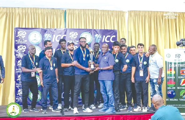 Obed Harvey, Black Batters captain, receiving the runners-up trophy from Richard Akpokavie, GOC President