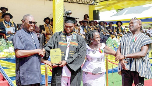 Dr Clement Abas Apak(left), Deputy Minister of Education, presenting an award to Kingsley Dzade (2nd from left), Valedictorian, at the graduation ceremony