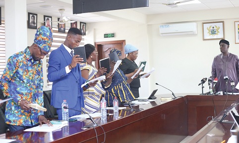 Haruna Iddrisu (right), Minister of Education, swearing in council members of the St John Bosco College of Education