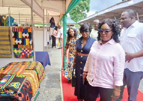 Rita Akosua Adjei Awatey, Eastern Regional Minister, and her entourage inspecting items on display during the Eastern Expo launch 