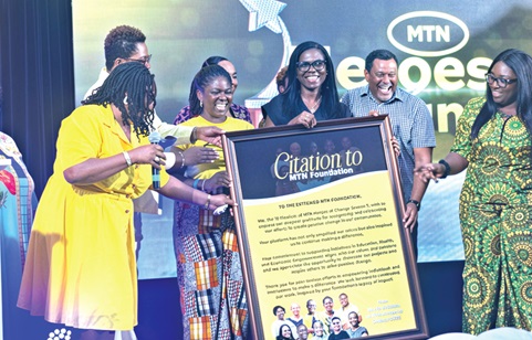 Adwoa Afriyie Wiafe (middle), the Chief Corporate Services and Sustainability Officer, receiving a citation from last season's finalists on behalf of MTN