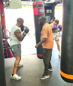 Daniel Oko Odamtten (right) taking one of his trainees through the drill at the gym