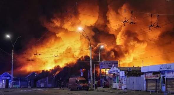 Firefighters work at the site of a book market hit by a Russian missile strike in Kyiv