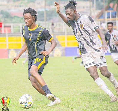 AshantiGold's Frederick Twumasi closes in on his Tamale City marker during the game