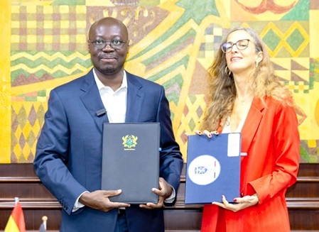 Dr Cassiel Ato Forson (left), Minister of Finance, and Carole van Eyll, Ambassador of Belgium, displaying the agreement