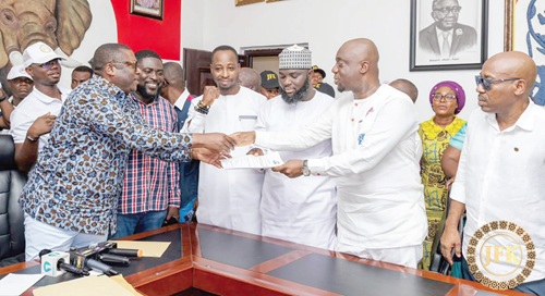 Justin Kodua Frimpong (2nd from right) presenting his nomination forms to Frederick Opare-Ansah (left), Chairperson of the National Elections Committee