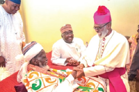 Most Rev. Charles Gabriel Palmer-Buckle, Metropolitan Archbishop of Cape Coast, exchanging pleasantries with Sheikh Usmanu Nuhu Sharubutu, the National Chief Imam, during a forum to strengthen and promote interfaith harmony. With them is Dr Mahamudu Bawumia, former Vice-President.